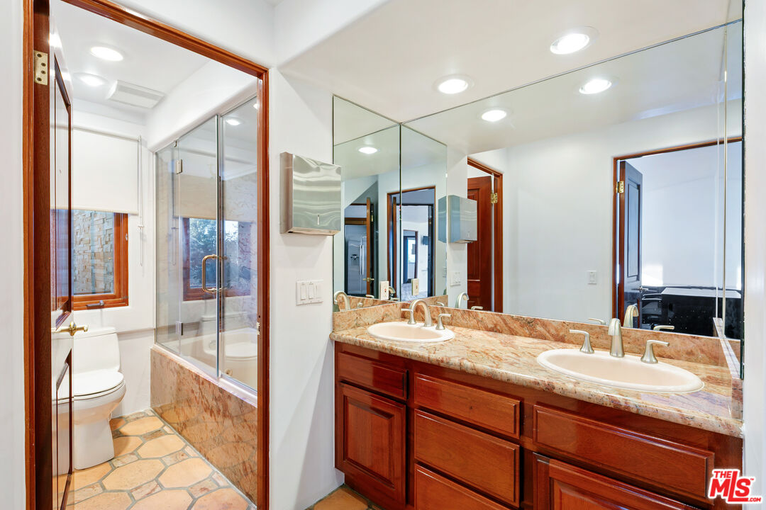 23000 Saddle Peak Road Topanga, CA 90290 - Photo 15 of 26 a bathroom with a granite countertop sink toilet and shower