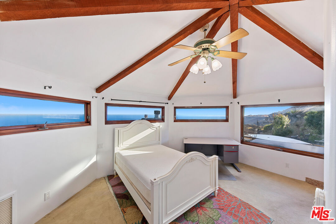 23000 Saddle Peak Road Topanga, CA 90290 - Photo 16 of 26 a bedroom with a bed and a window