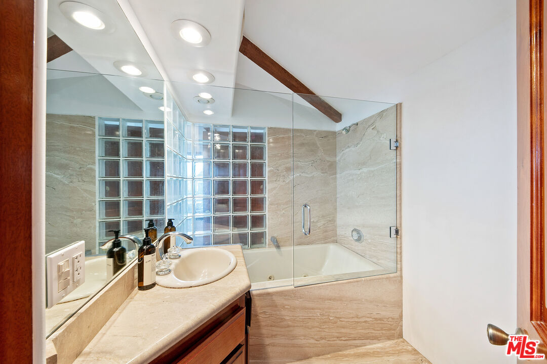 23000 Saddle Peak Road Topanga, CA 90290 - Photo 18 of 26 a bathroom with a granite countertop sink mirror bathtub and next to a window
