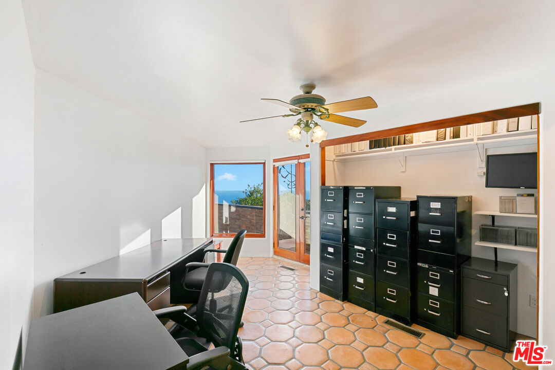 23000 Saddle Peak Road Topanga, CA 90290 - Photo 9 of 26 a bedroom with a bed and cabinets