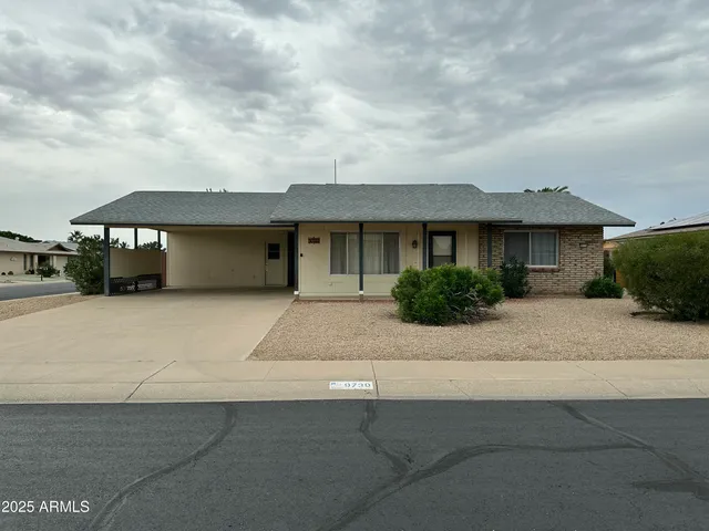 a front view of a house with a yard and a garage