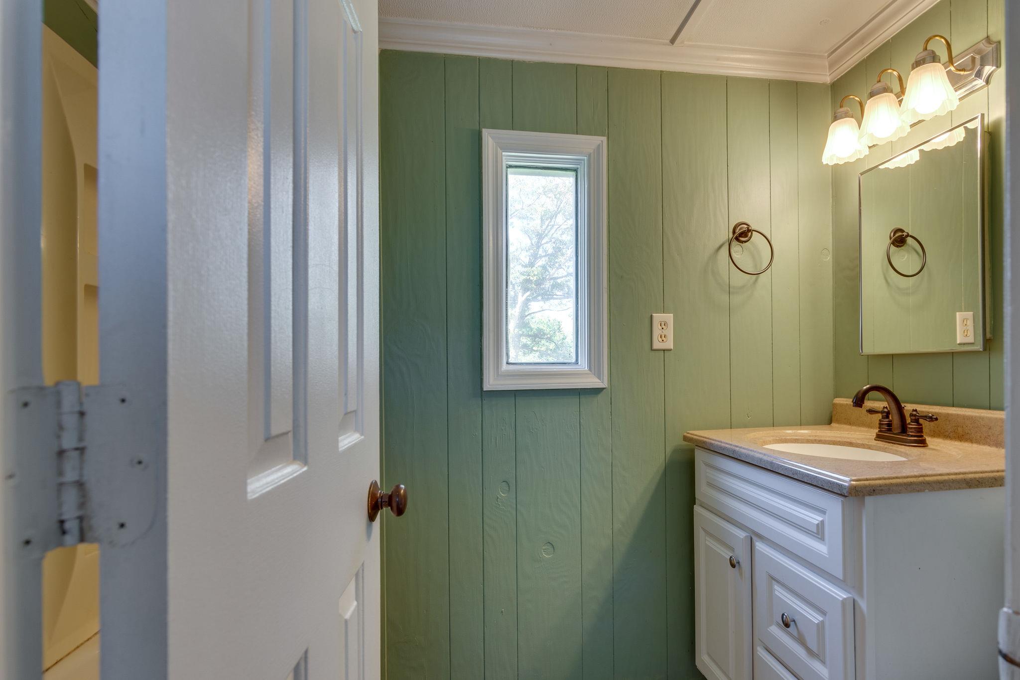 5029 Will Brown Road Spring Hill, TN 37174 - Photo 14 of 24 a bathroom with a sink a light fixture and a mirror