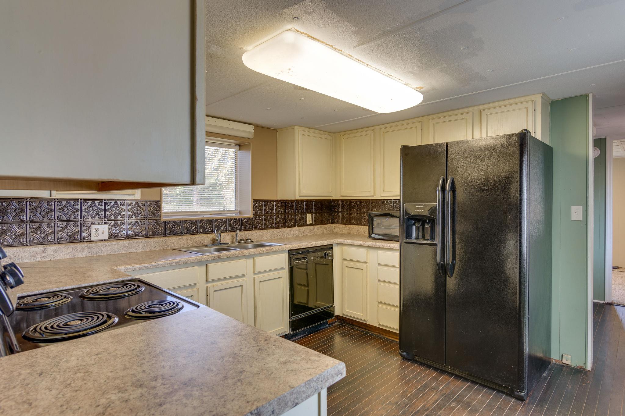 5029 Will Brown Road Spring Hill, TN 37174 - Photo 6 of 24 a kitchen with a refrigerator stove and sink