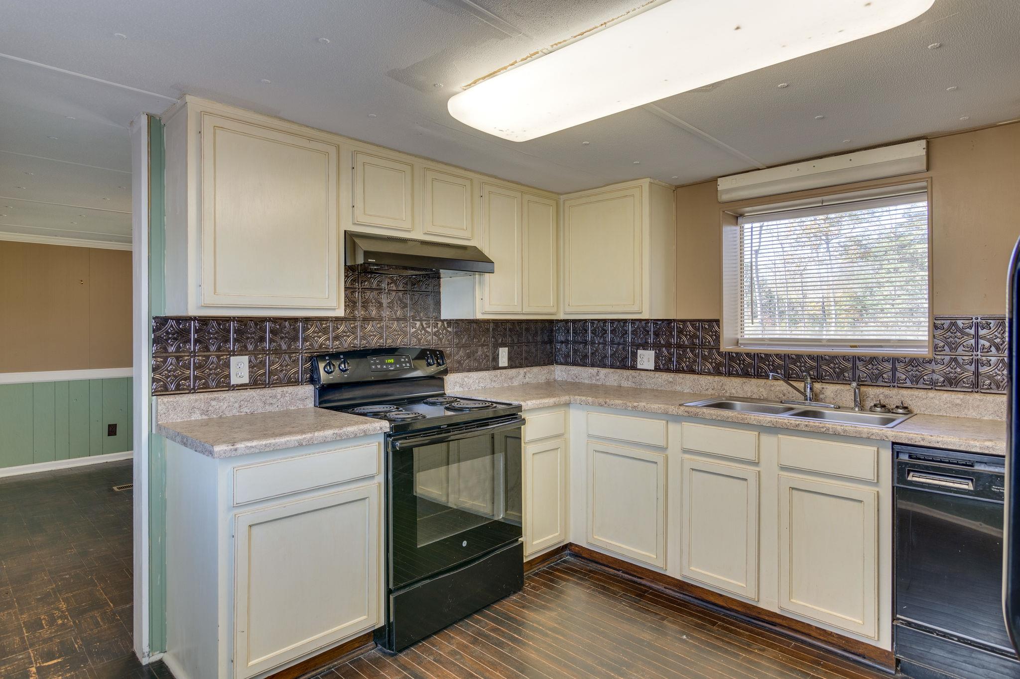 5029 Will Brown Road Spring Hill, TN 37174 - Photo 7 of 24 a kitchen with a sink stove and cabinets