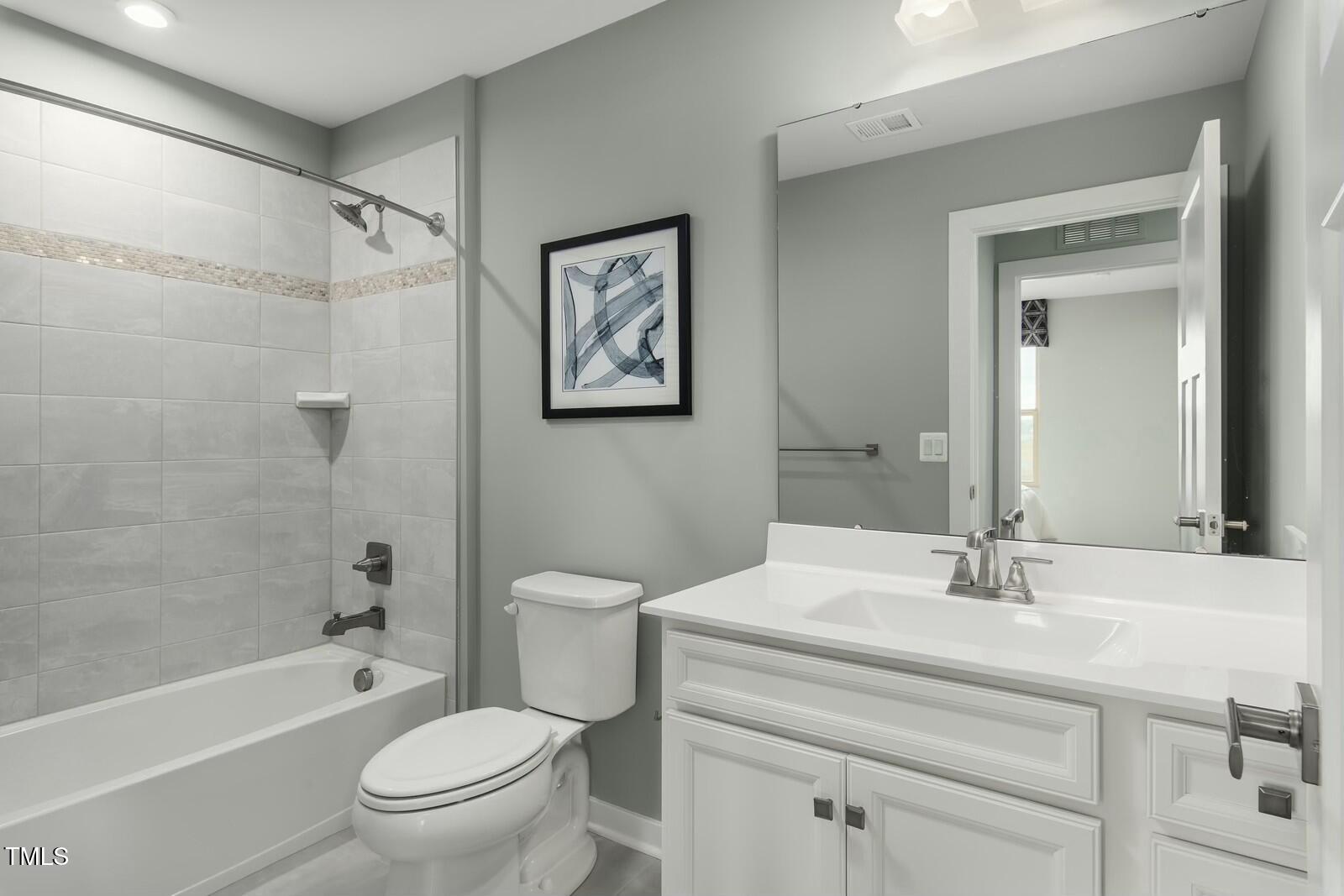 425 Grand Silo Road Raleigh, NC 27603 - Photo 10 of 12 a bathroom with a sink toilet and a bathtub