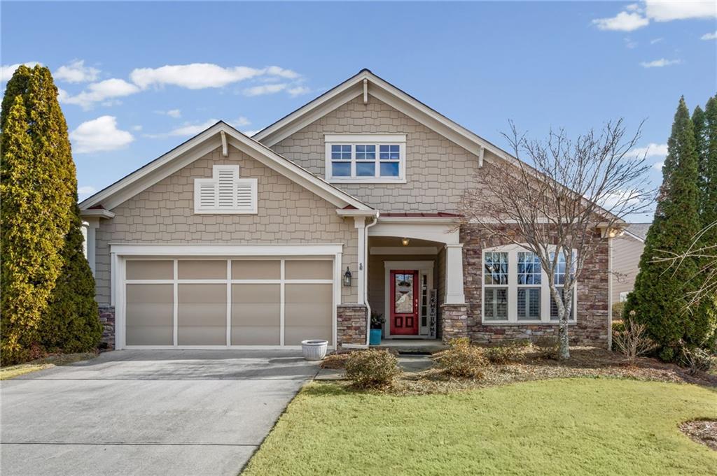 a front view of a house with a yard and garage
