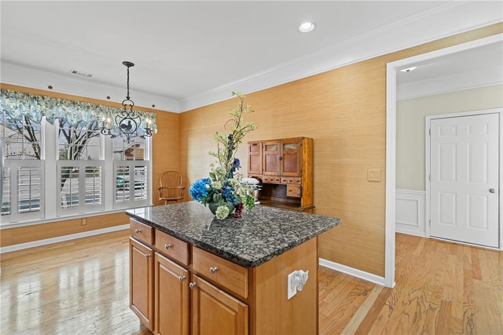 4945 Kings Common Way Cumming, GA 30040 - Photo 14 of 40 a bathroom with a granite countertop sink and a mirror