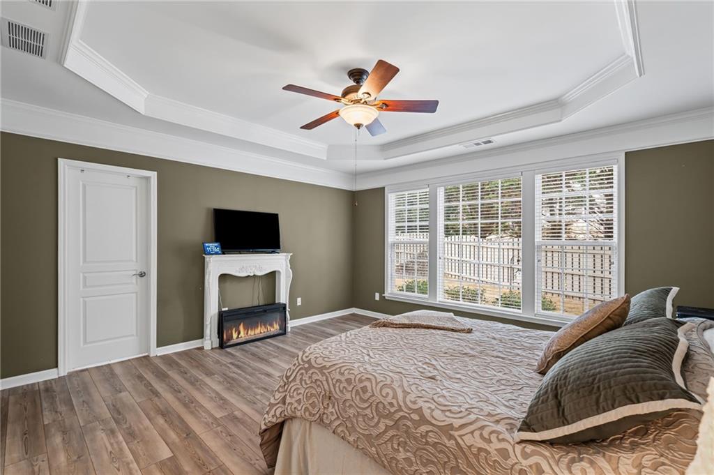 4945 Kings Common Way Cumming, GA 30040 - Photo 20 of 40 a bedroom with a bed and a flat screen tv