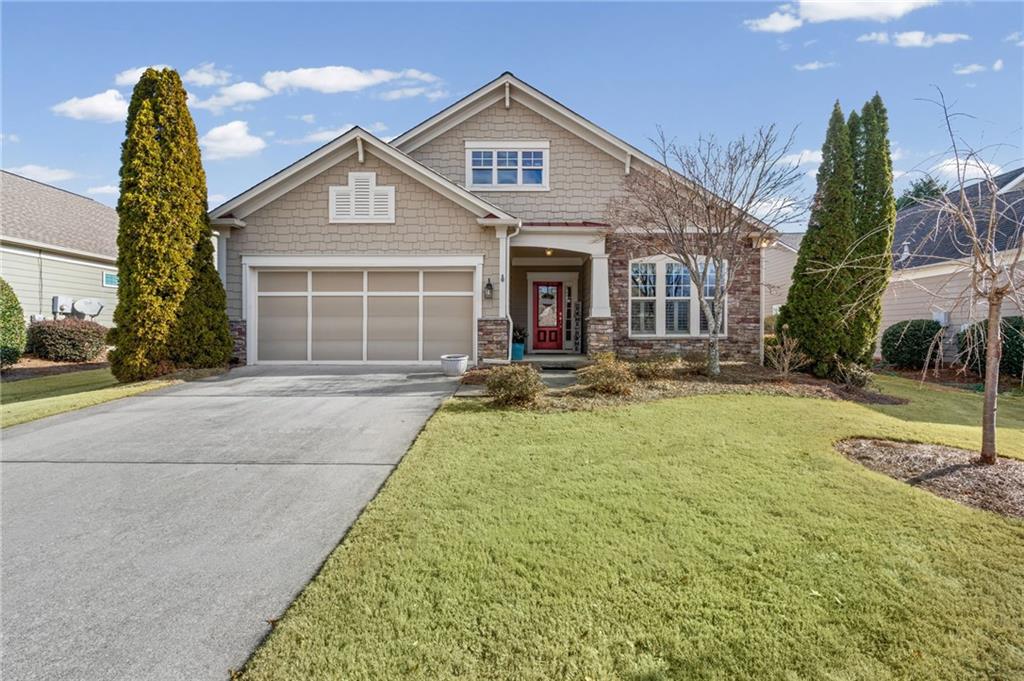 4945 Kings Common Way Cumming, GA 30040 - Photo 2 of 40 a front view of a house with a yard