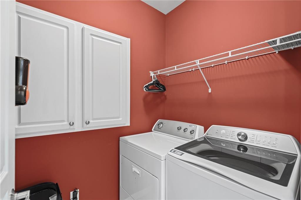 4945 Kings Common Way Cumming, GA 30040 - Photo 28 of 40 a utility room with dryer and washer