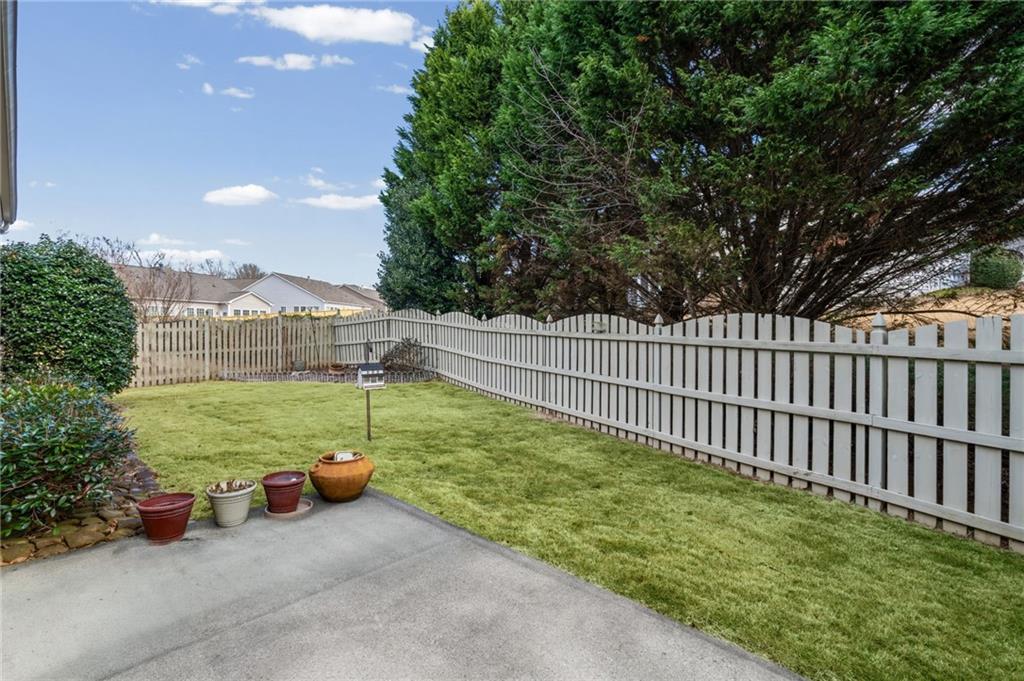 4945 Kings Common Way Cumming, GA 30040 - Photo 29 of 40 a view of a garden with an outdoor seating