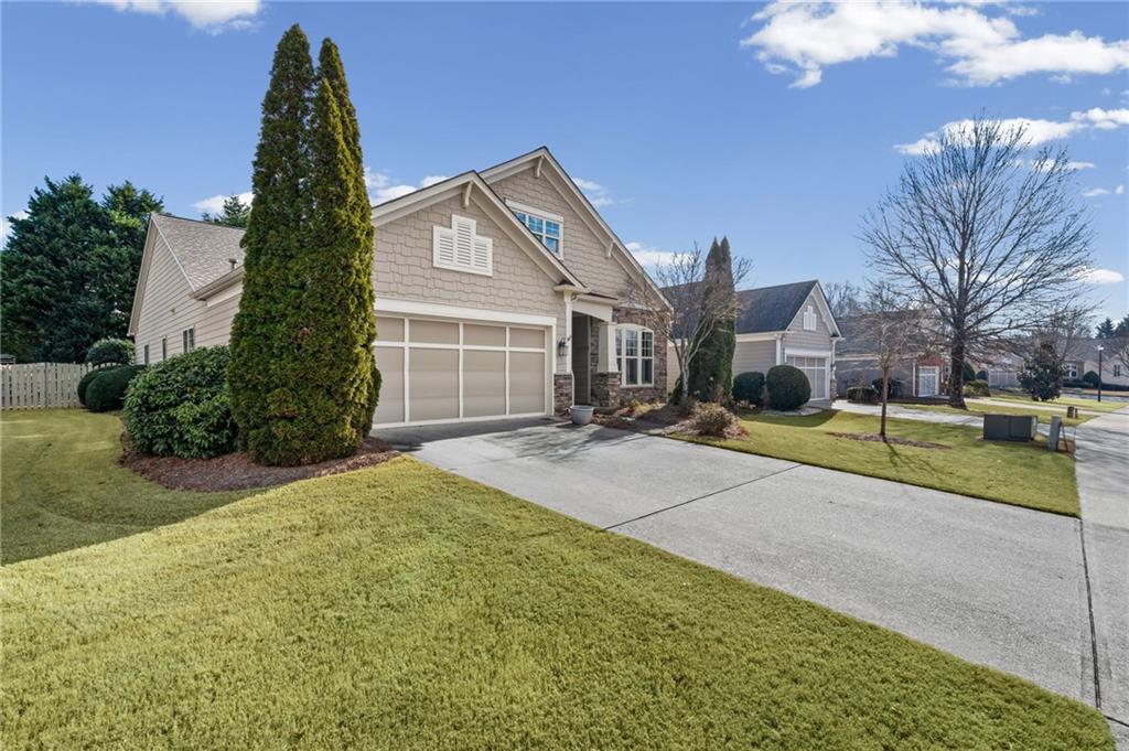 4945 Kings Common Way Cumming, GA 30040 - Photo 3 of 40 a house view with a outdoor space