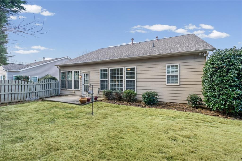 4945 Kings Common Way Cumming, GA 30040 - Photo 32 of 40 a view of a house with backyard and sitting area