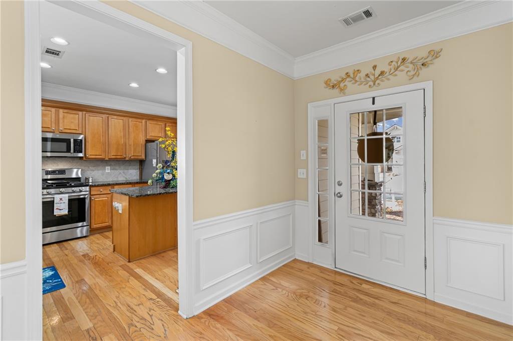 4945 Kings Common Way Cumming, GA 30040 - Photo 7 of 40 a view of kitchen with stainless steel appliances granite countertop a stove and a refrigerator