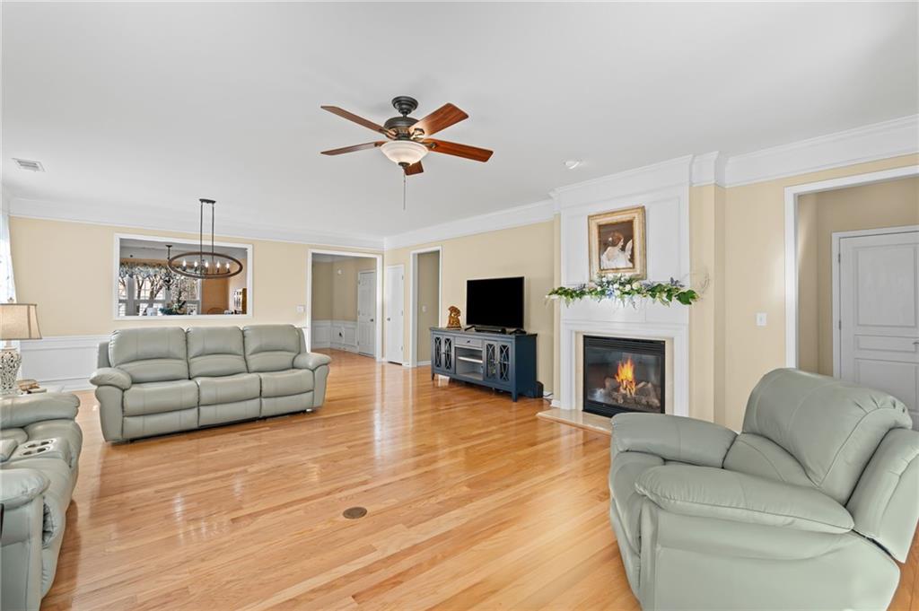4945 Kings Common Way Cumming, GA 30040 - Photo 8 of 40 a living room with furniture a fireplace and a flat screen tv
