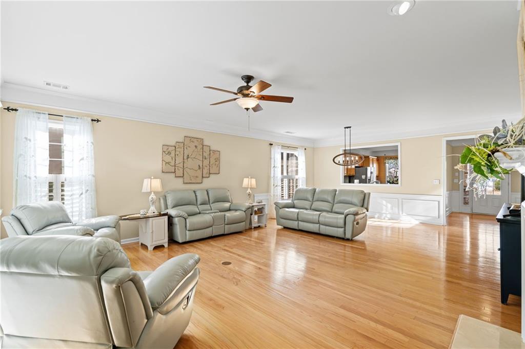 4945 Kings Common Way Cumming, GA 30040 - Photo 9 of 40 a living room with furniture and a large window