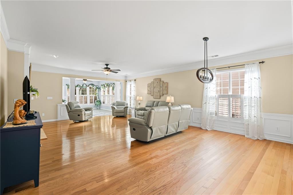 4945 Kings Common Way Cumming, GA 30040 - Photo 10 of 40 a view of a livingroom with furniture wooden floor and window