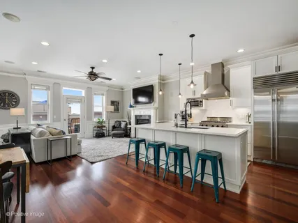 a large kitchen with cabinets counter space dining table and stainless steel appliances