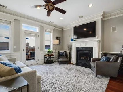 a living room with furniture flat screen tv and a fireplace