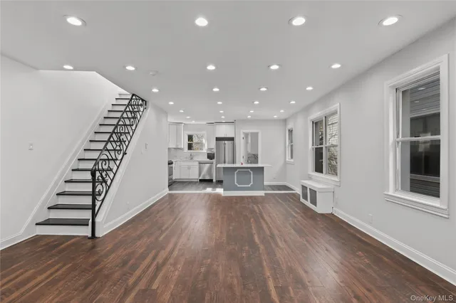 a view of wooden floor and windows in a room