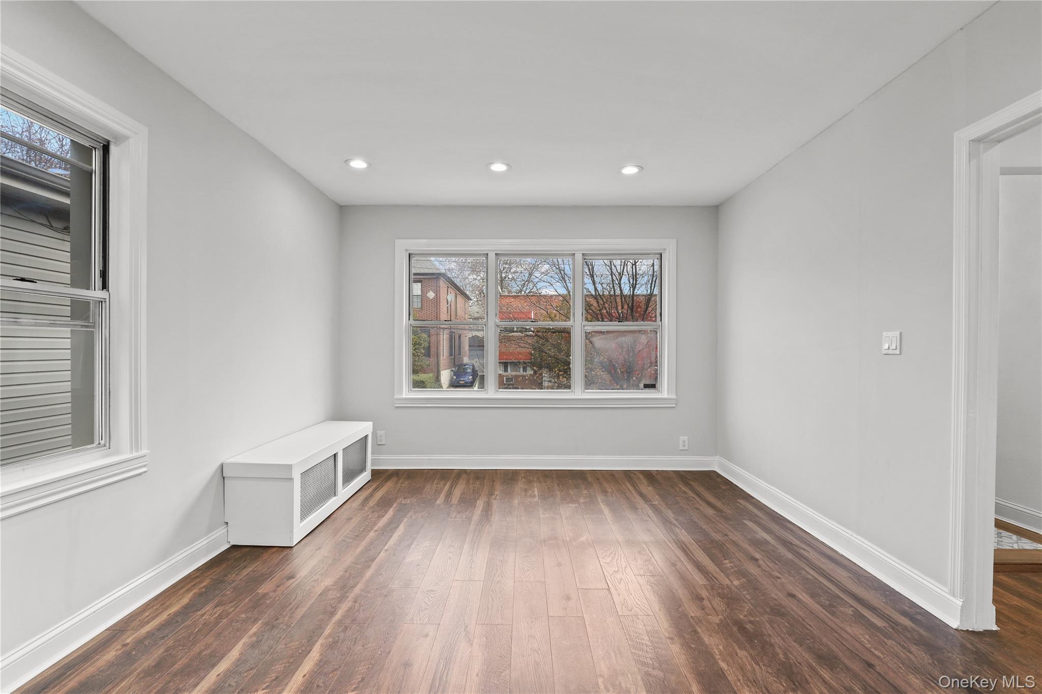 1631 Paulding Avenue Bronx, NY 10462 - Photo 9 of 22 a view of an empty room with wooden floor and a window