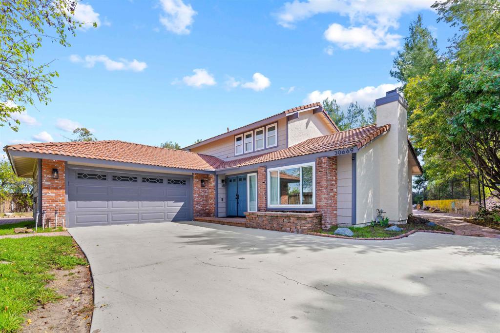 30669 Southern Cross Road Temecula, CA 92592 - Photo 1 of 1 a front view of a house with a yard and garage