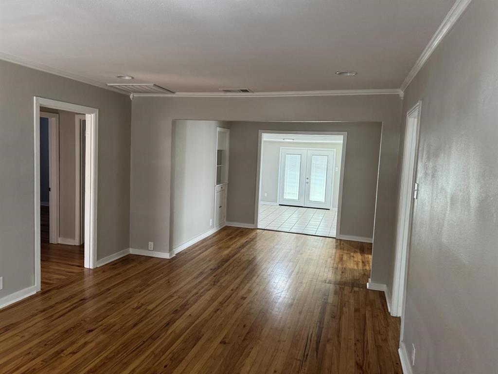 8427 Ridgelea Street Dallas, TX 75209 - Photo 6 of 17 a view of empty room with wooden floor and fan