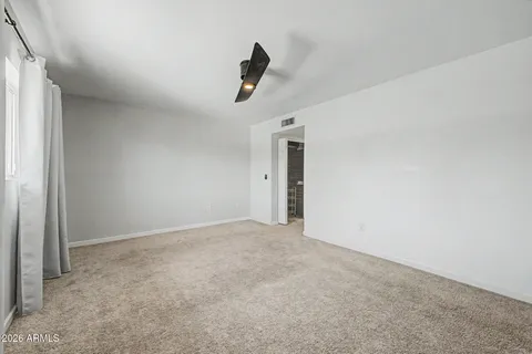 a view of an empty room and a window