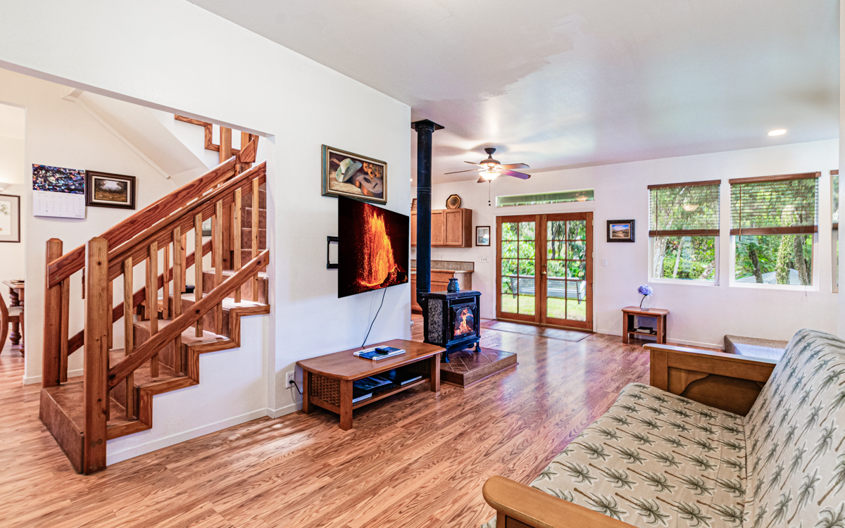 99-1846 Painiu Loop Volcano, HI 96785 - Photo 12 of 30 a living room with furniture a rug and a window