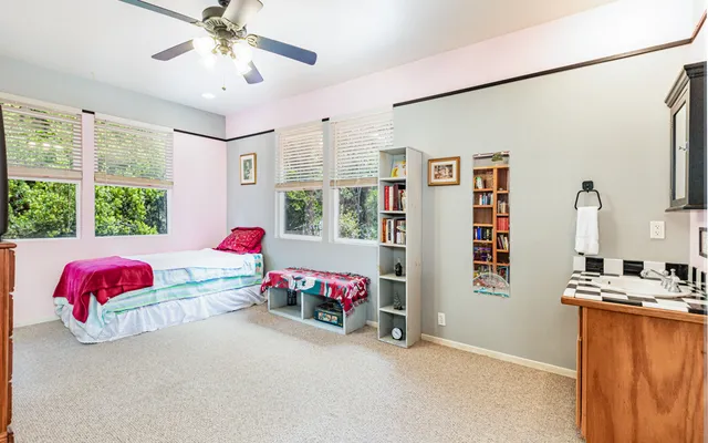 a bedroom with furniture and a large window