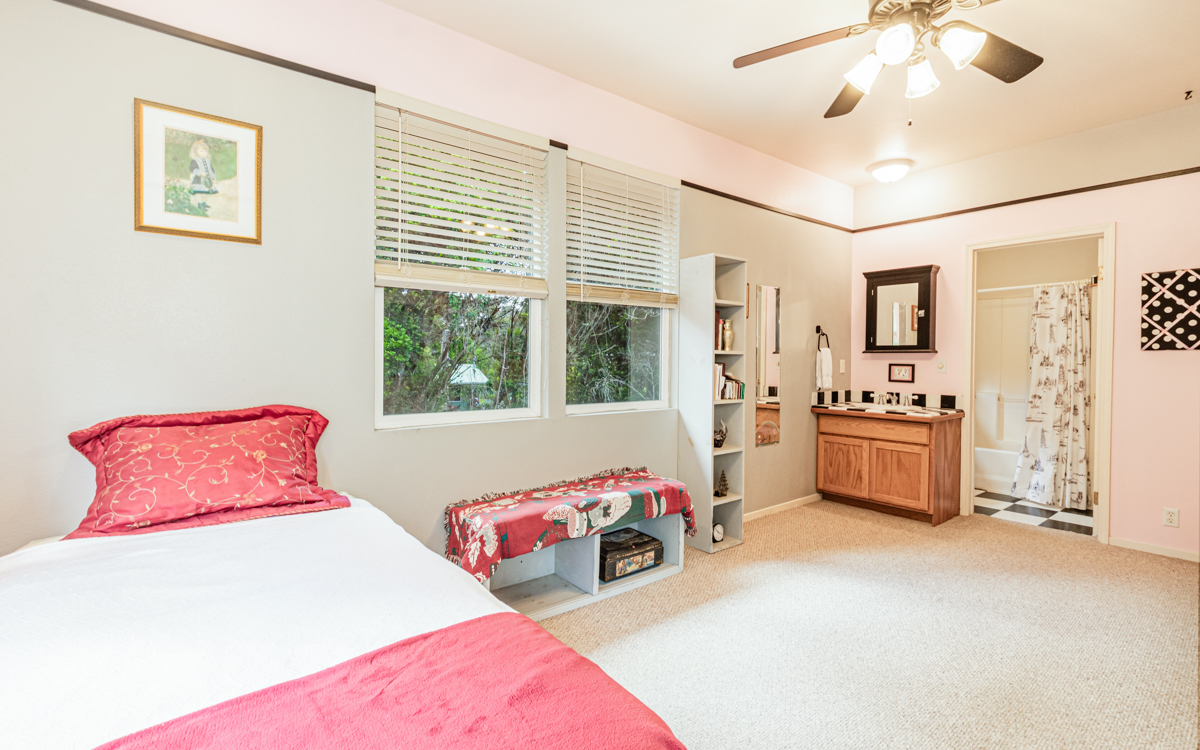 99-1846 Painiu Loop Volcano, HI 96785 - Photo 23 of 30 a bedroom with furniture and a large window