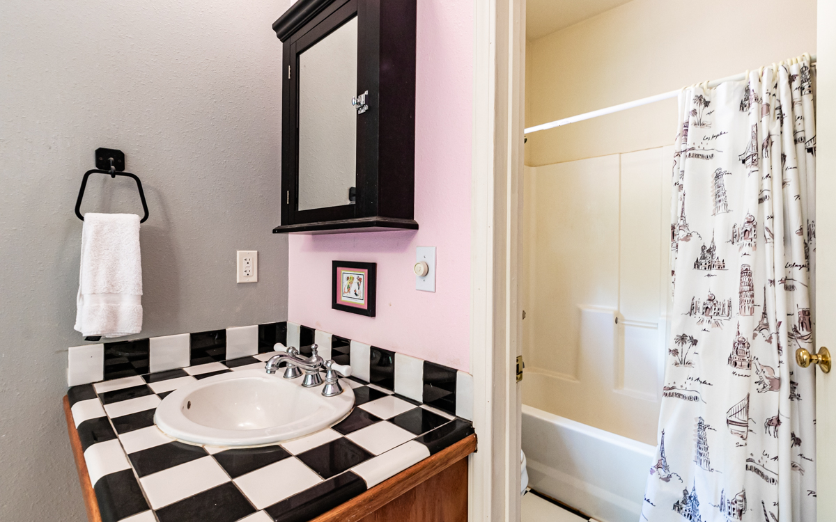 99-1846 Painiu Loop Volcano, HI 96785 - Photo 24 of 30 a bathroom with a sink and a mirror