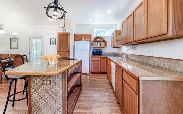 a kitchen with stainless steel appliances granite countertop a sink and cabinets