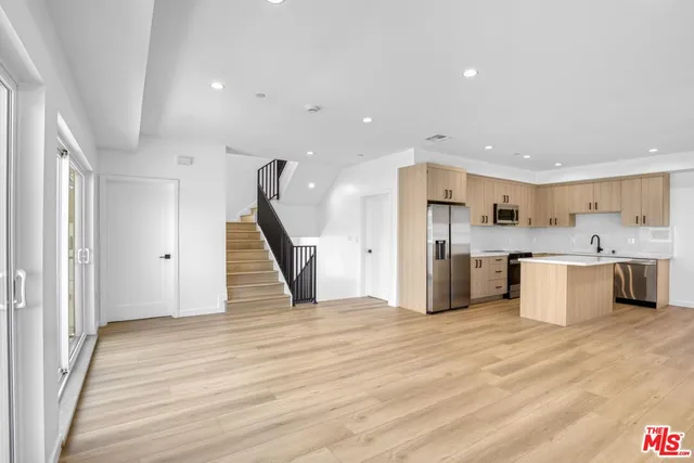 a view of kitchen with cabinets microwave and stainless steel appliances