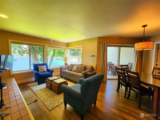 a living room with furniture and large windows
