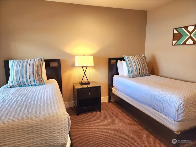 a bedroom with a bed and lamp