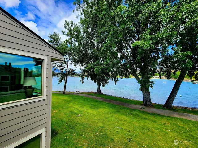 a view of a porch in front of a house with a tree
