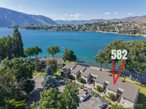 an aerial view of a house with a lake view