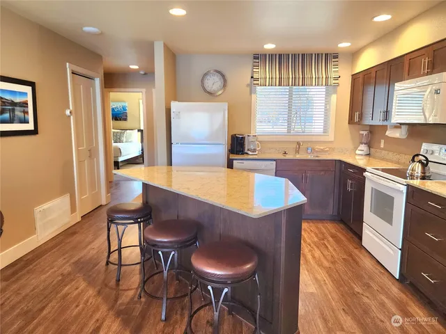 a kitchen with a table chairs sink and cabinets