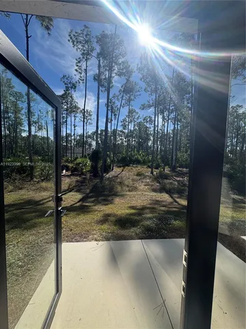 a view of a yard from a corridor