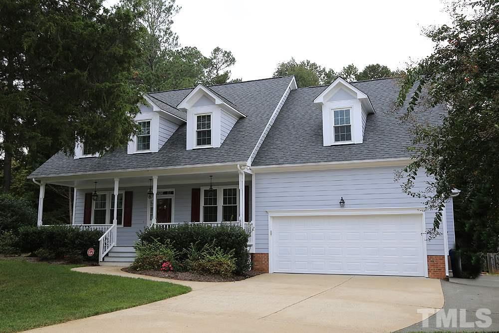 8203 Kitzel Way Raleigh, NC 27615 - Photo 1 of 14 a front view of a house with a yard and garage