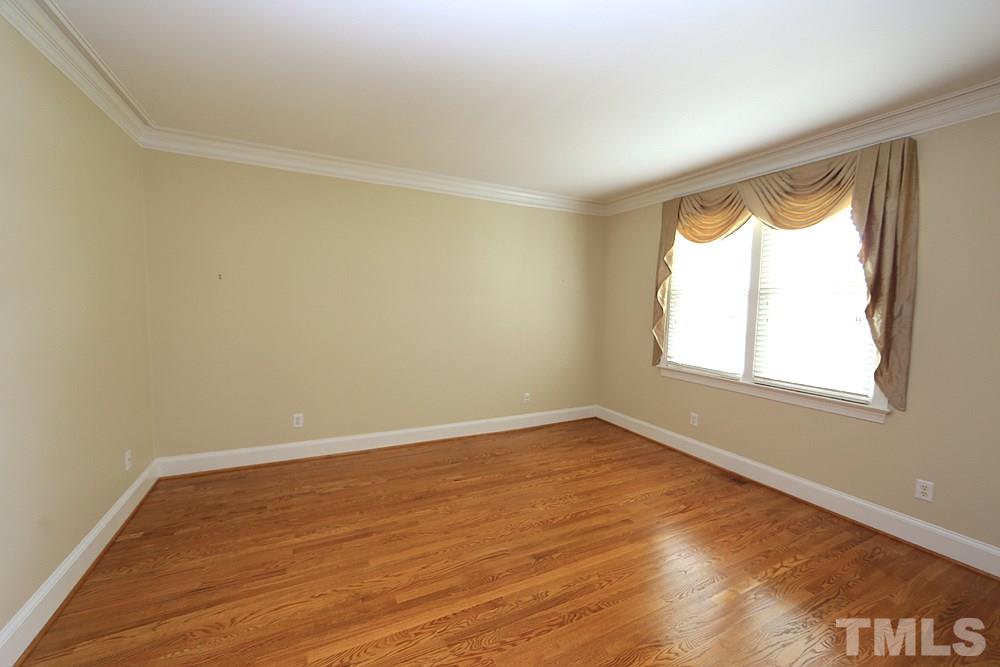 8203 Kitzel Way Raleigh, NC 27615 - Photo 2 of 14 wooden floor in an empty room with a window
