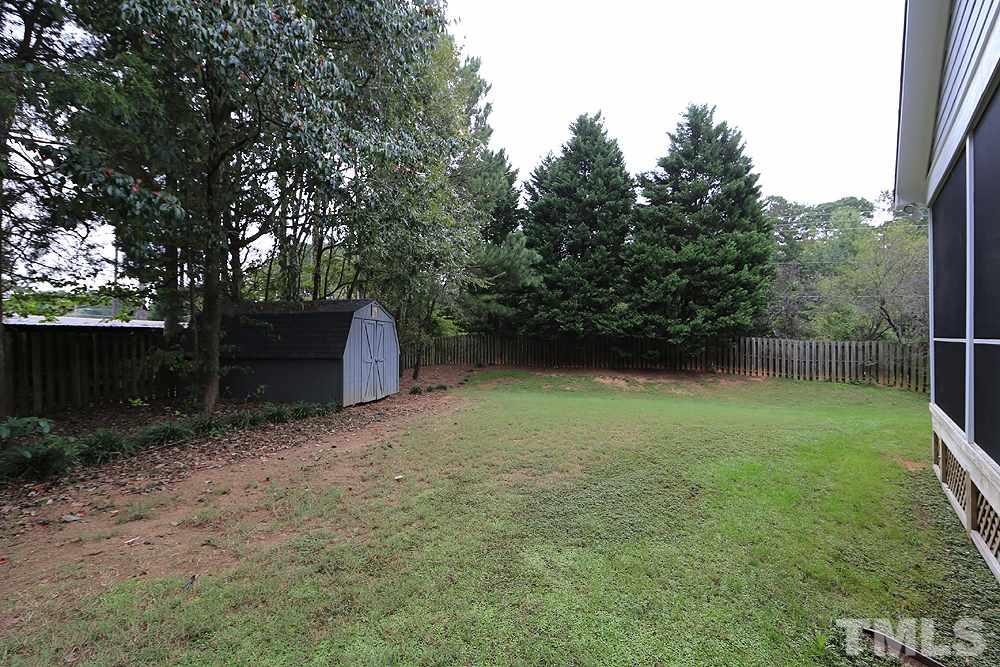 8203 Kitzel Way Raleigh, NC 27615 - Photo 14 of 14 a backyard of a house with lots of green space