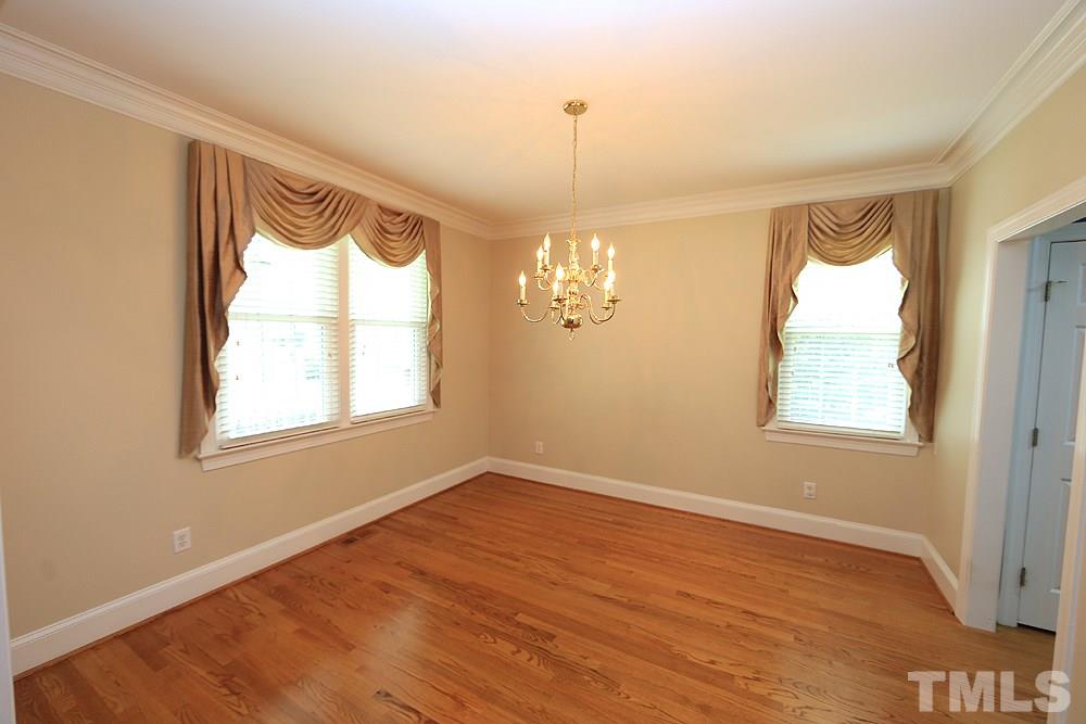 8203 Kitzel Way Raleigh, NC 27615 - Photo 3 of 14 a view of an empty room with a window and wooden floor