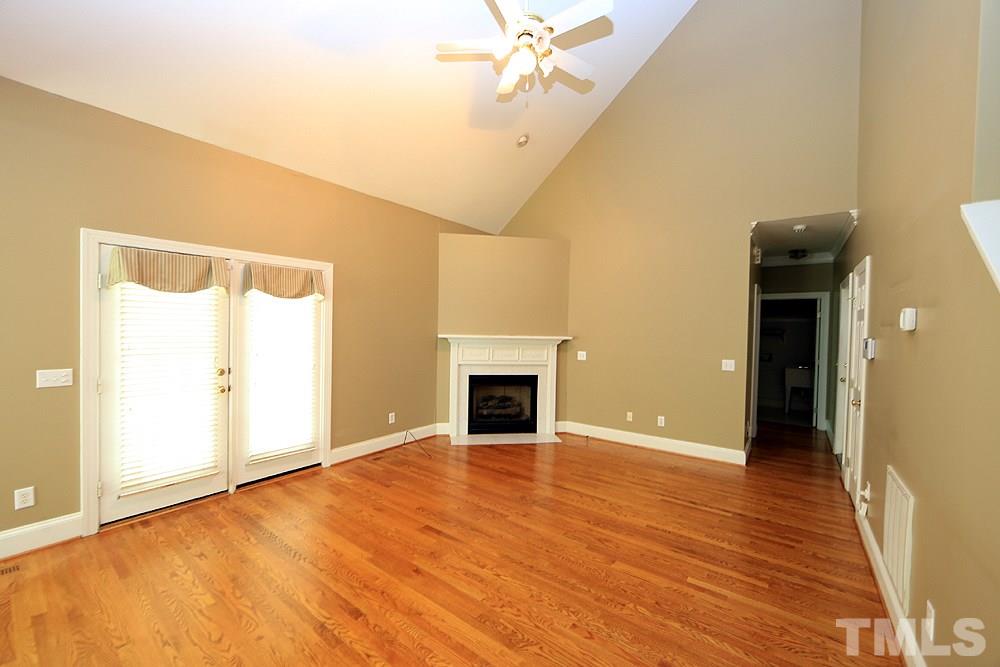 8203 Kitzel Way Raleigh, NC 27615 - Photo 6 of 14 wooden floor fireplace and windows in an empty room