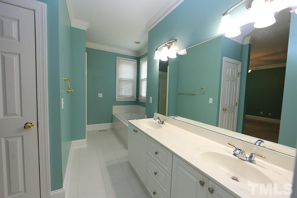 8203 Kitzel Way Raleigh, NC 27615 - Photo 8 of 14 a spacious bathroom with a double vanity sink mirror and shower