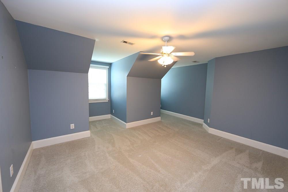 8203 Kitzel Way Raleigh, NC 27615 - Photo 10 of 14 a view of a chandelier fan and fire place