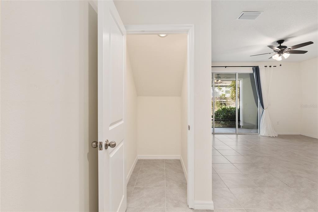 13818 Northwest 9th Road Newberry, FL 32669 - Photo 12 of 56 a view of a hallway with a chandelier fan and windows