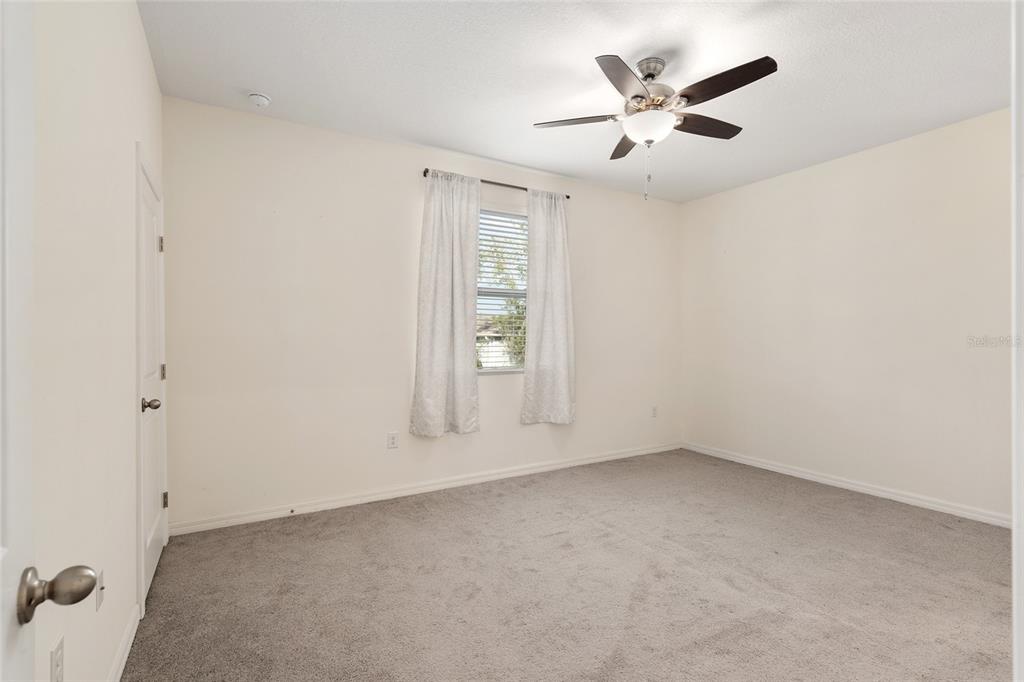 13818 Northwest 9th Road Newberry, FL 32669 - Photo 20 of 56 an empty room with ceiling fan and window