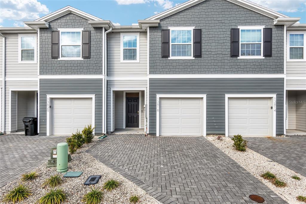 13818 Northwest 9th Road Newberry, FL 32669 - Photo 29 of 56 a front view of a house with a yard and garage